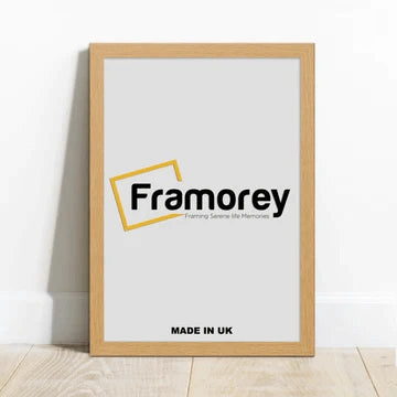 Oak Picture frame with a Framorey Logo is leaning with the wall on a wooden Surface. 